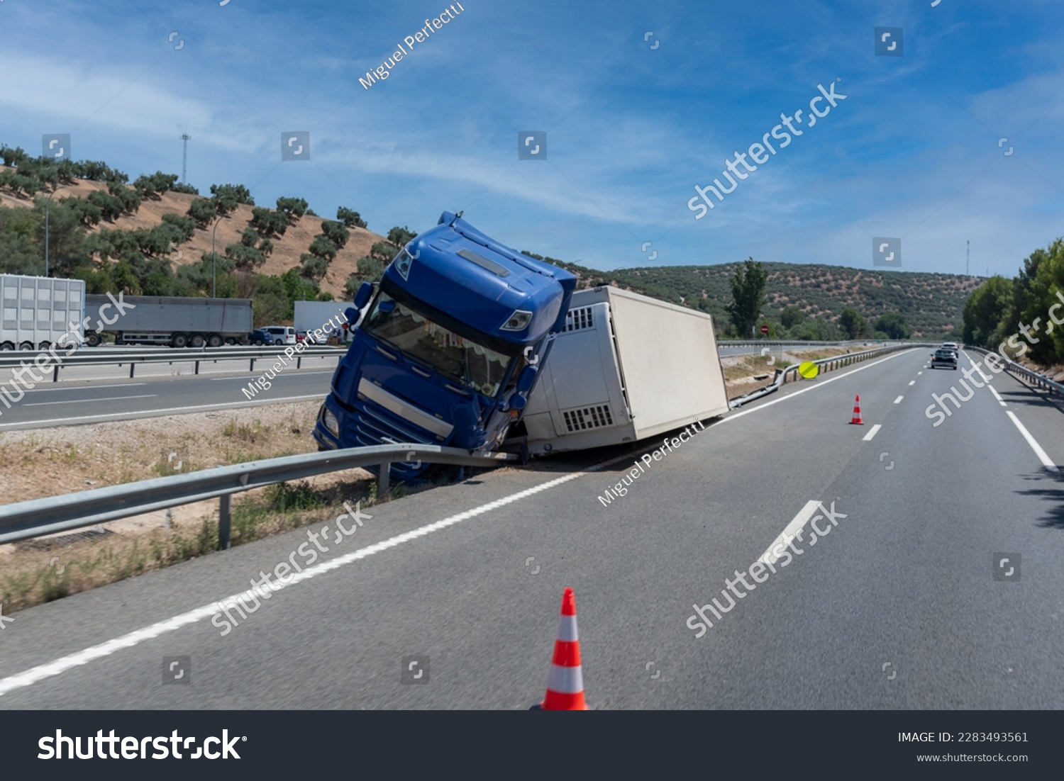 stock-photo-truck-with-an-accident-refrigerated-semi-trailer-overturned-by-the-exit-of-the-highway-in-the-2283493561