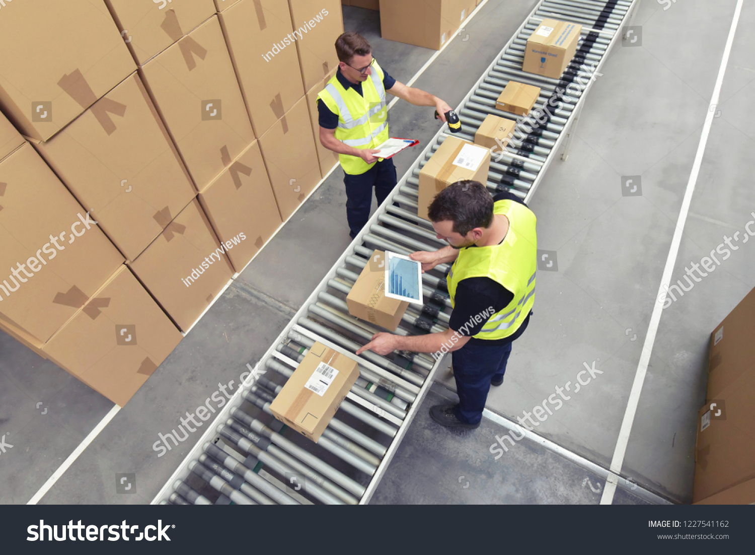 stock-photo-worker-in-a-warehouse-in-the-logistics-sector-processing-packages-on-the-assembly-line-transport-1227541162